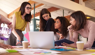 Creative team collaborating around a laptop with GoToConnect